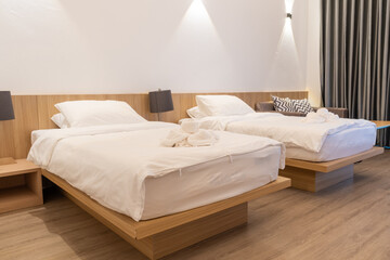 Bedroom and two single white beds in hotel room in northen Thailand.