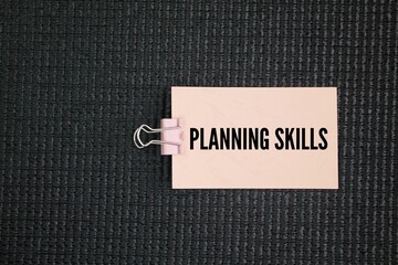Paper with the words planning skills. concept of how to plan wisely. the ability to effectively...