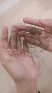 Realistic footage of hair fall, showing fragile strands in hand. Symbolizes stress, thinning hair, or daily beauty problems many face.

