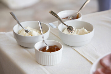 Delicious breakfast with ricotta cheese and jam served on a white tablecloth