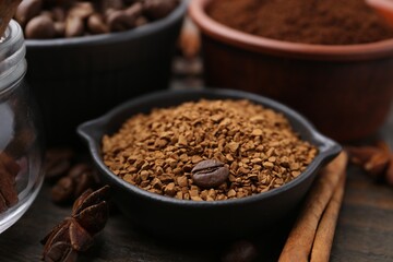 Instant (granulated) coffee, bean and spices on wooden table, closeup