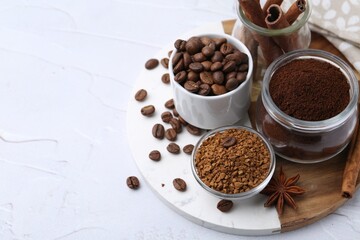 Different types of instant coffee, beans and spices on light textured table, closeup. Space for text