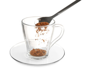 Putting granulated instant coffee into cup isolated on white