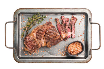 BBQ Grilled and sliced Chuck eye roll steak, marbled beef meat in a steel tray isolated on white...