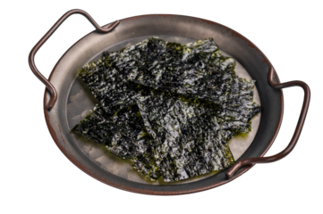 Nori seaweed sheets on a plate isolated on white background. top view