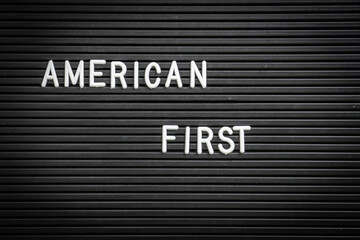 American First phrase on framed letter board. Close-up view of the words “American First”...
