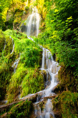 The Urach waterfall on the edge of the Swabian Alb in Baden-Württemberg is one of the largest waterfalls in Germany. A natural spectacle and attraction on a sunny summer's day after heavy rain.