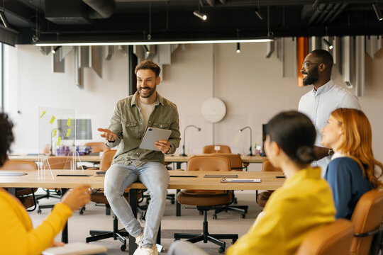 Office workers in a modern workspace having a group meeting and brainstorming session