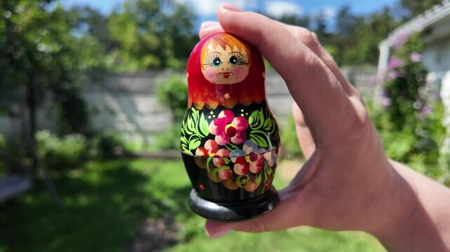 wooden matryoshka doll. Hand Holding a Wooden Matryoshka Doll &ndash; Traditional Russian Nesting Doll. Collection of traditional Russian nesting dolls. Beautiful handmade matryoshka dolls in a row.