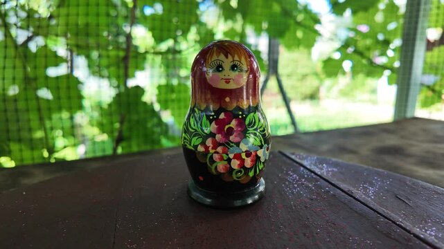 wooden matryoshka doll. Hand Holding a Wooden Matryoshka Doll &ndash; Traditional Russian Nesting Doll. Collection of traditional Russian nesting dolls. Beautiful handmade matryoshka dolls in a row.