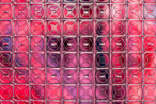Colorful abstract glass panel background with red and pink gradient pattern