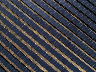 Aerial view of solar panel and power station with energy storage.