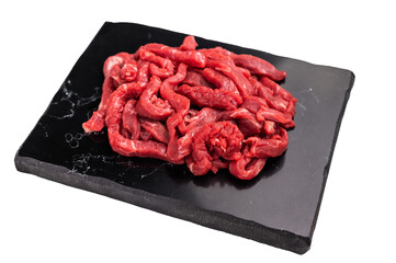 Pieces of Raw beef sliced meat, strips for cooking beef stroganov on board isolated on white...