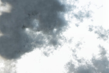 heavy clouds against a backdrop of lighter, wispier clouds and a pale sky.  The contrast highlights...