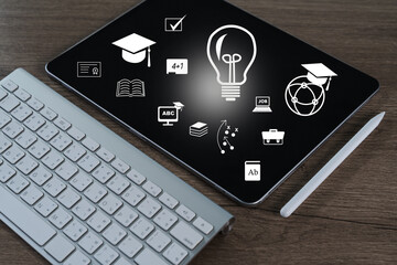 Student success tablet with educational icons and stylus wooden surface, representing learning and innovation, evokes creativity and knowledge