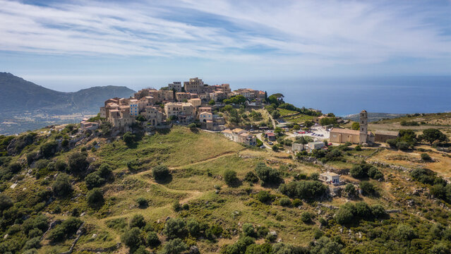 Aerial view of the medieval hilltop village of Sant&rsquo;Antonino on the island of Corsica with the Meidterranean sea in the distance