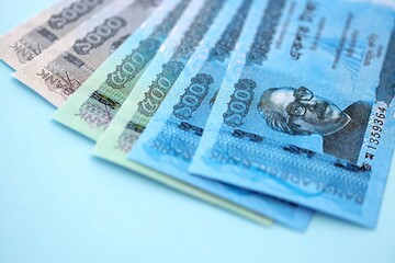 Bangladeshi taka money bills in big amount lies on teal color table close up