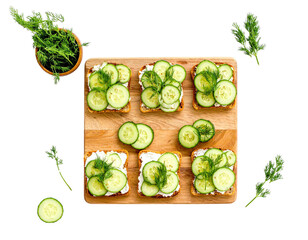 Cucumber Sandwiches with Dill on Wooden Board – Top View

