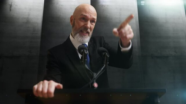 Angry head of dystopian country speaking at a podium on concrete wall background