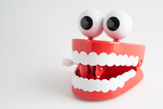 Funny red teeth with eye toy denture model for dental health care.