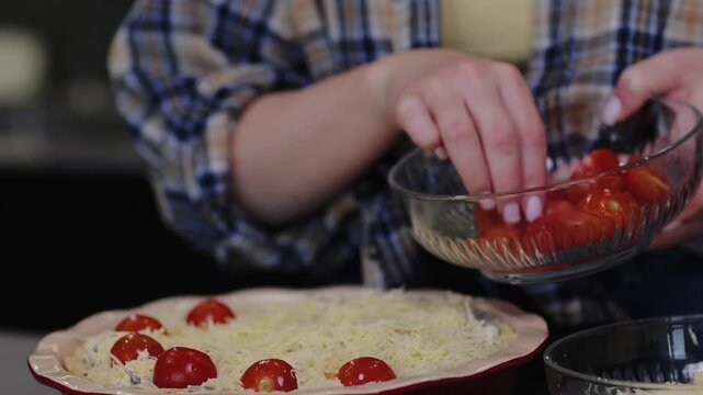 Young woman preparing quiche in the kitchen
