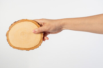 Wooden coaster for drinking water or props for taking photos in hand with a white background