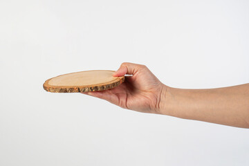 Wooden coaster for drinking water or props for taking photos in hand with a white background