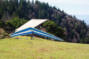 Soaring heights with gliders in vibrant blue and white fabric ready to take off from a grassy...
