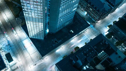 Aerial cityscape with illuminated skyscrapers at night.