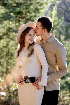 A Couple Joyfully Celebrating Their Pregnancy Announcement Surrounded by Beautiful Nature
