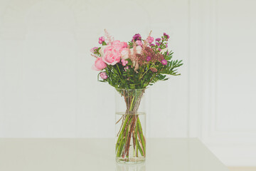 Pink rose bouquet. Natural fresh flowers in glass vase on white background