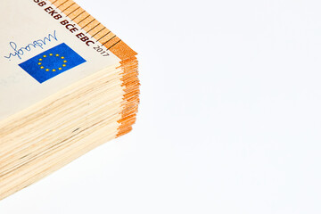 Corner of stack of 50 euro 2017 banknotes over white background close up with copy space.