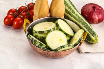 Raw green zucchini slices for cooking