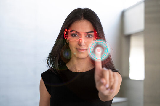Woman wearing AR glasses interacting with a virtual screen