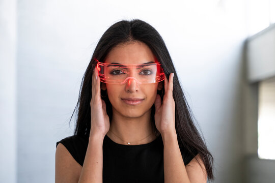 Woman wearing AR glasses indoors looking at camera