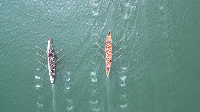 Paignton, Torbay, South Devon, England: DRONE VIEW: Overhead view of a gig boat crew during a training session. Torbay is a popular UK holiday destination and a magnet for water sports enthusiasts.