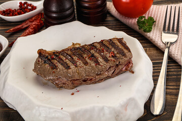 Grilled beef striploin steak with sauce