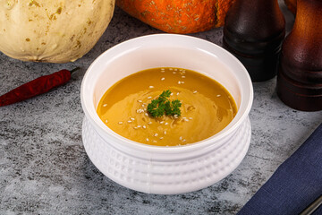 Vegan pumpkin cream soup served sesam