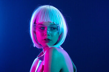 Futuristic woman in neon light with holographic smart glasses