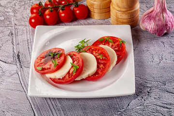 Italian caprese salad with mozzarella, tomato and basil