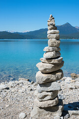 cairn at the lake shore of blue lake Walchensee, upper bavaria