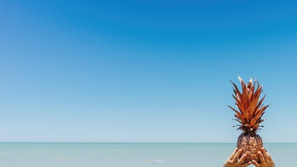 Metallic Pineapple 3D Render Held by Hands on Beach for Commercial Design