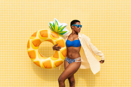 Woman with short hair holding inflatable ring