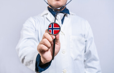 Doctor hands holding stethoscope with Norway flag. Norway health and care concept