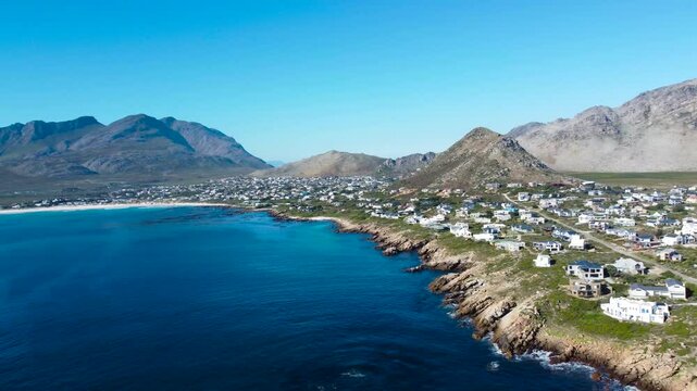 Camera panning left to right over the small town of Pringle Bay, 4K aerial video