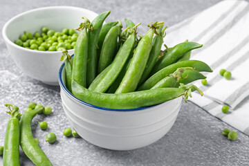 Fresh ripe green peas on grey table, closeup