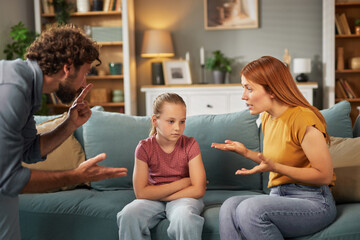 Parents engage in a serious conversation regarding their child’s actions while the young girl...