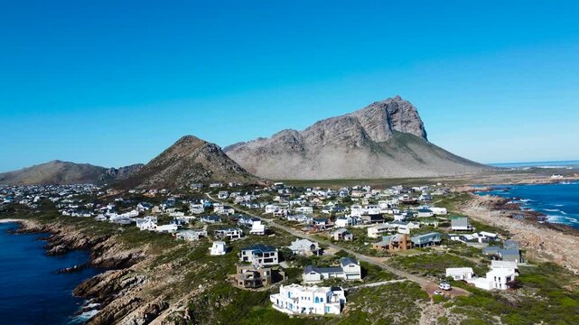 Camera rising up to reveal the small town of Pringle Bay, 4K aerial video