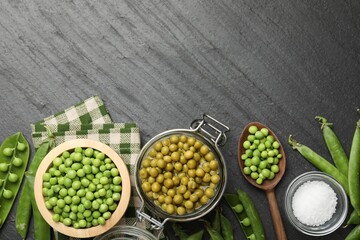 Pickled peas, salt and pods on black table, flat lay. Space for text