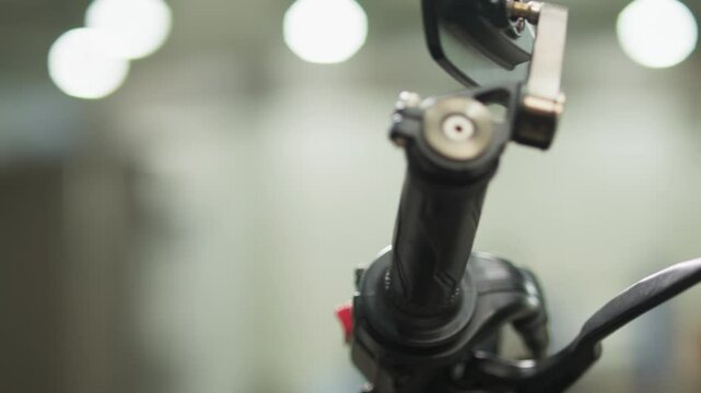 Close-Up of a Woman&rsquo;s Hand Twisting Motorcycle Throttle and Turning It Off &ndash; Everyday Transportation Scene